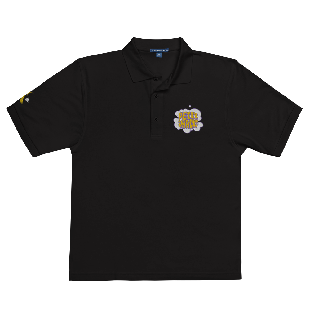 Black short sleeved, collared polo t-shirt. Embroidery logo on left side of chest. Embroidery of a white cloud of smoke with purple outline, and yellow bubble lettering inside reading "Petty Snacks". An embroidered logo of the cartoon banana holding up a shaka is on the right sleeve.