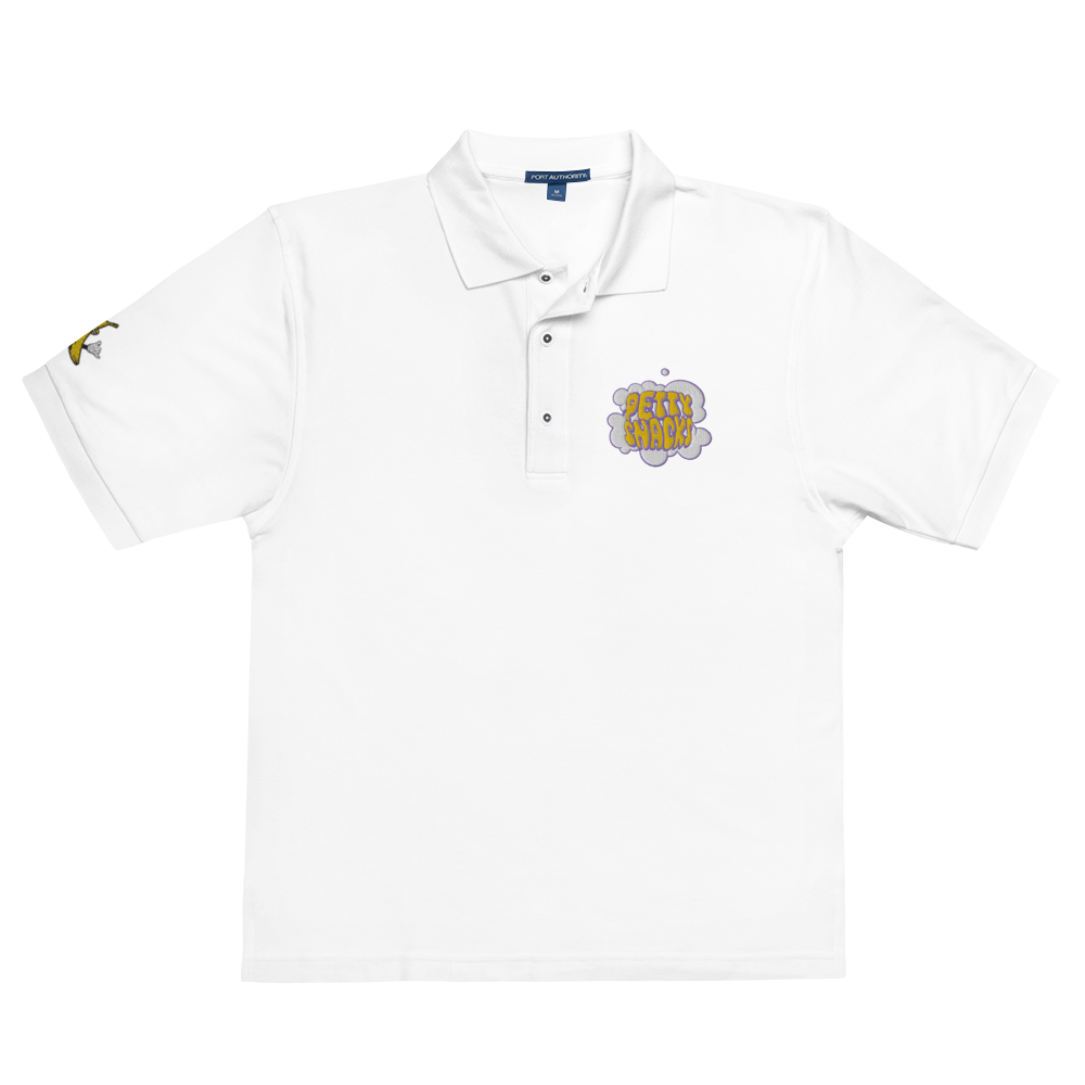 White short sleeved, collared polo t-shirt. Embroidery logo on left side of chest. Embroidery of a white cloud of smoke with purple outline, and yellow bubble lettering inside reading "Petty Snacks". An embroidered logo of the cartoon banana holding up a shaka is on the right sleeve.